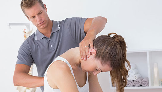 Woman receiving chiropractic adjustment from a Ohio chiropractor