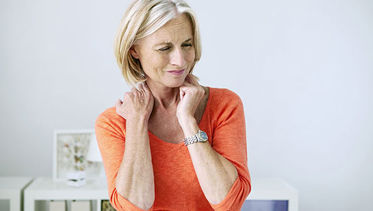 Mature woman suffering from neck and shoulder pain before visiting Ohio chiropractor