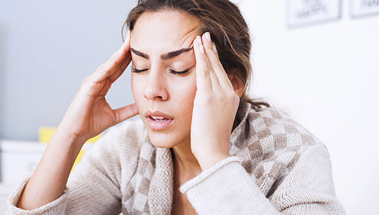 Woman suffering from headache before visiting Ohio chiropractor